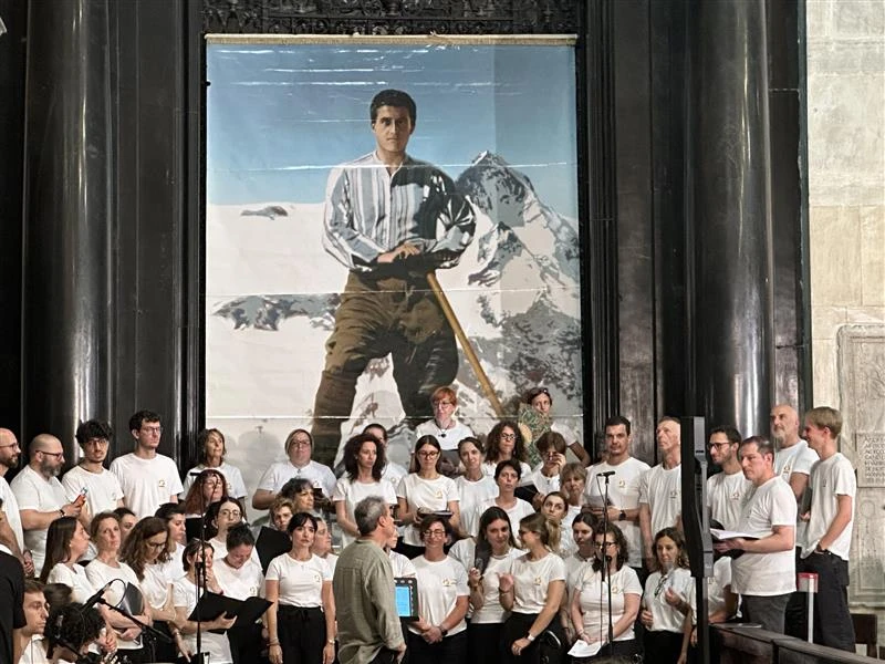 A choir poses before an image of Pier Giorgio Frassati during a celebration of the centenary of his death, Turin, Italy, Friday, July 4, 2025.?w=200&h=150