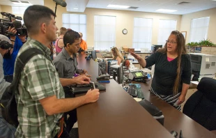 Kim Davis (at right) is pictured here in 2015, when she served as clerk of the courts in Rowan County, Kentucky. Citing a sincere religious objection, Davis refused to issue marriage licenses to same-sex couples in defiance of a U.S. Supreme Court ruling. Credit: Ty Wright/Getty Images