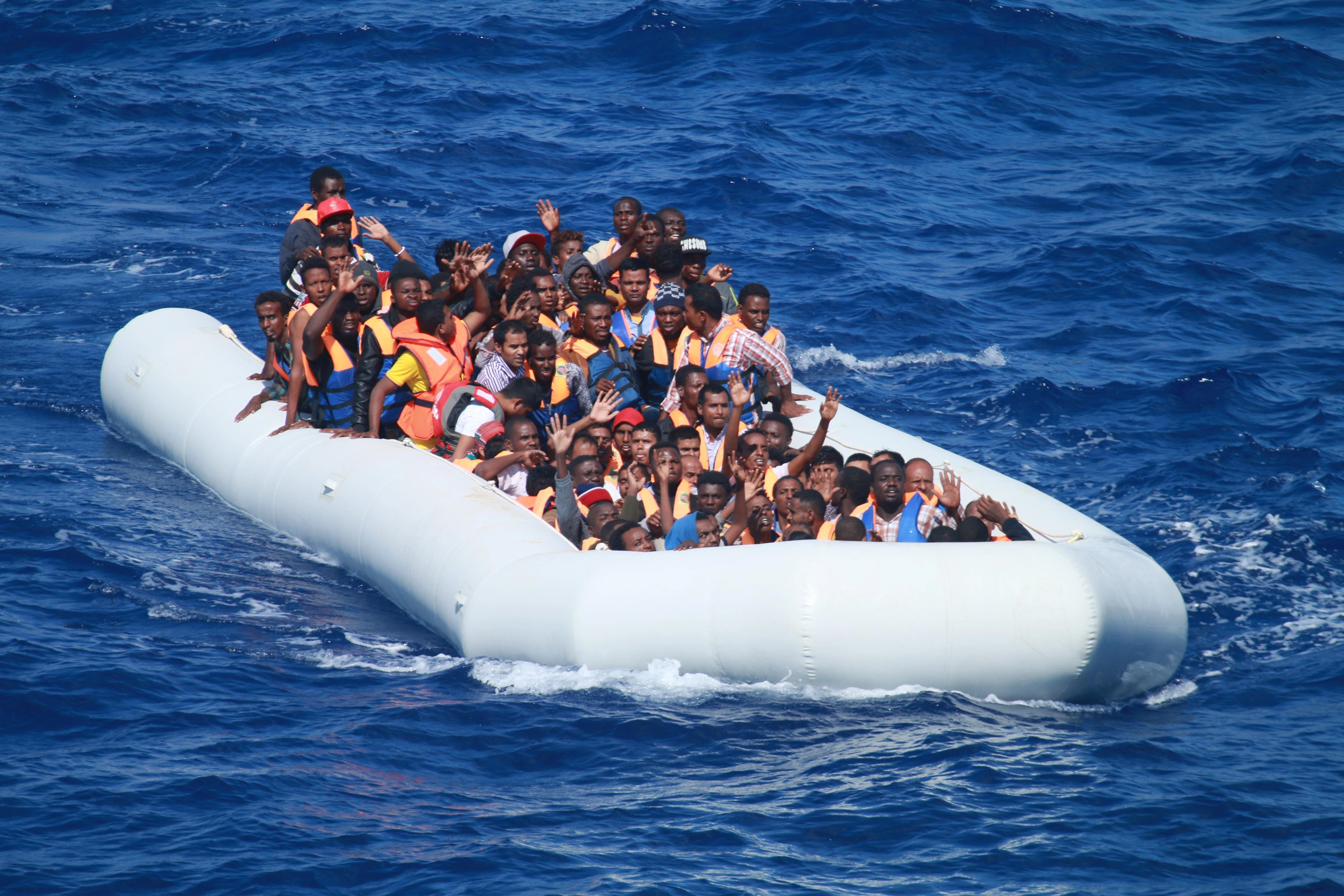 Migrants aboard an inflatable vessel in the Mediterranean Sea approach the guided-missile destroyer USS Carney in 2013. Carney provided food and water to the migrants aboard the vessel before coordinating with a nearby merchant vessel to take them to safety.?w=200&h=150