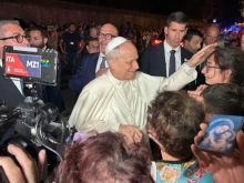 Pope Leo XIV greets the faithful at the gates of Castel Gandolfo on Aug. 19, 2025.