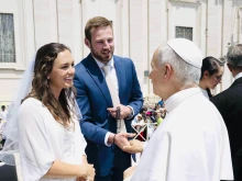 Newlyweds Anna and Cole Stevens meet Pope Leo XIV at the general audience in Rome on Wednesday, June 11, 2025.