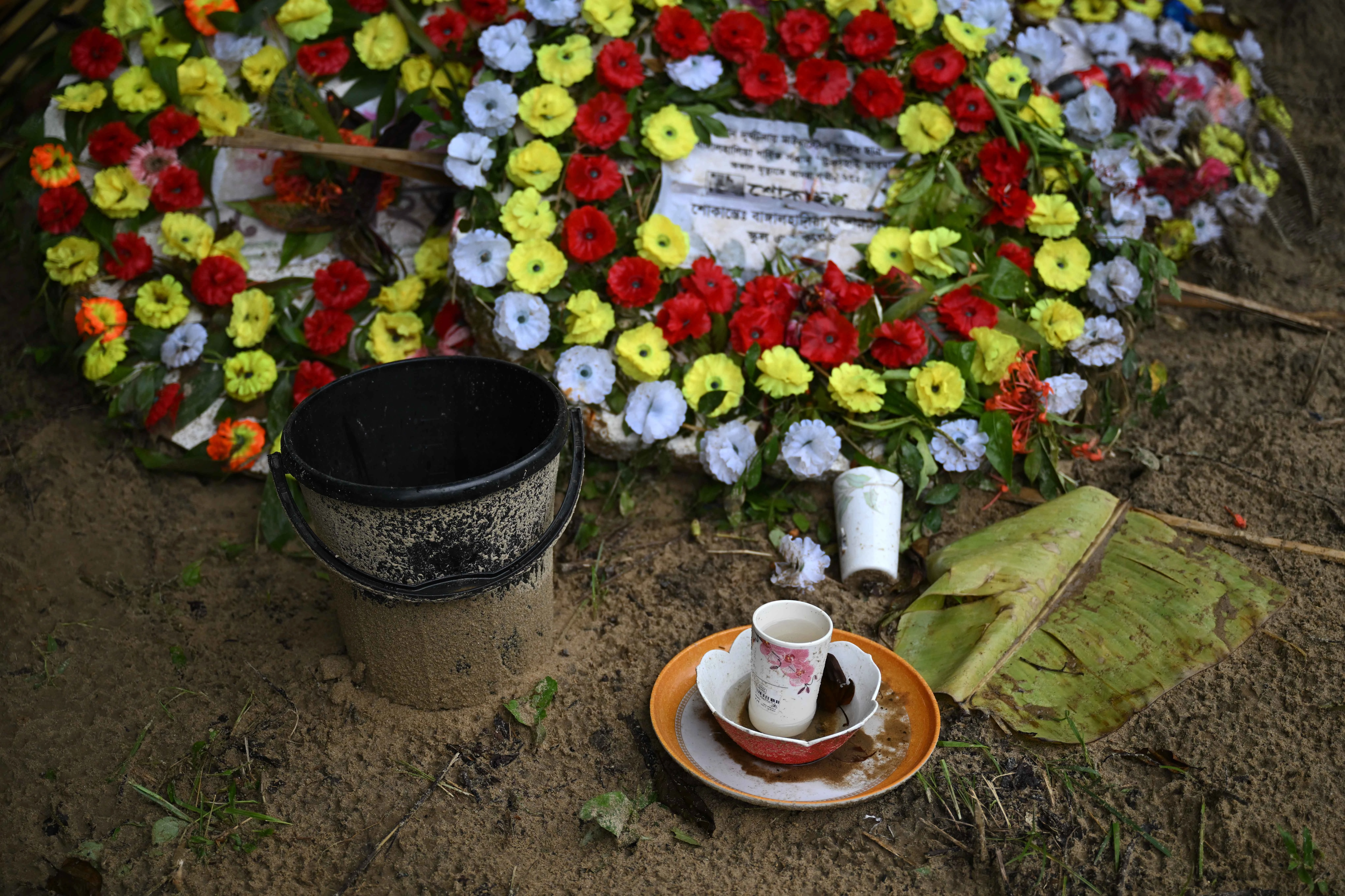 Flowers and offerings are placed at the grave of Ukya Chhaing Marma. The seventh-grader died from his wounds after being rescued from a July 21, 2025, plane crash at his Dhaka school.?w=200&h=150