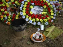 Flowers and offerings are placed at the grave of Ukya Chhaing Marma. The seventh-grader died from his wounds after being rescued from a July 21, 2025, plane crash at his Dhaka school.