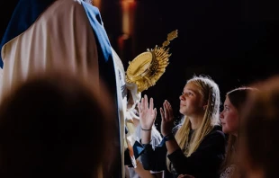 A high school camper venerates the Eucharist at Wednesday night adoration in 2024 at the Damascus main campus, Centerburg, Ohio. Credit: Photo courtesy of Damascus Media Staff