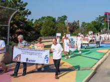 Members of the Catholic nonprofit Strangers No Longer and others march to the Detroit ICE headquarters in July 2025.