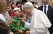 Pope Leo XIV greets a young papal admirer in St. Peter’s Basilica during the general audience on Wednesday, Aug. 20, 2025, at the Vatican.