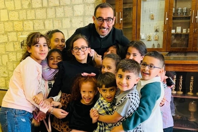 Father Bashar Fawadleh, Latin rite pastor of Taybeh, with children from his community.?w=200&h=150
