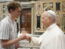 Pope Leo XIV greets a young pilgrim in Rome during a meeting with group of teachers and young people from Denmark, England, Ireland, Scotland, and Wales, Saturday, July 5, 2025.