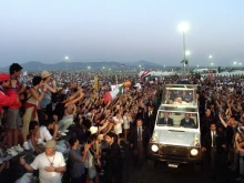 Pope John Paul II blesses young faithful as he arrives at Tor Vergata campus to take part in World Youth Day on Aug. 19, 2000. More than 2 million young people turned out under a blazing sun to see the pope.