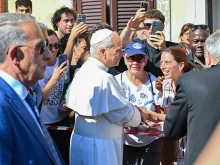Pope Leo XIV greets people as he arrives for a two-week stay in the summer papal estate in Castel Gandolfo, 25 miles southeast of Rome, on July 6, 2025. The newly elected pope revives a long-standing papal tradition paused under Francis, as Castel Gandolfo prepares to welcome a pope for the first time in over a decade.