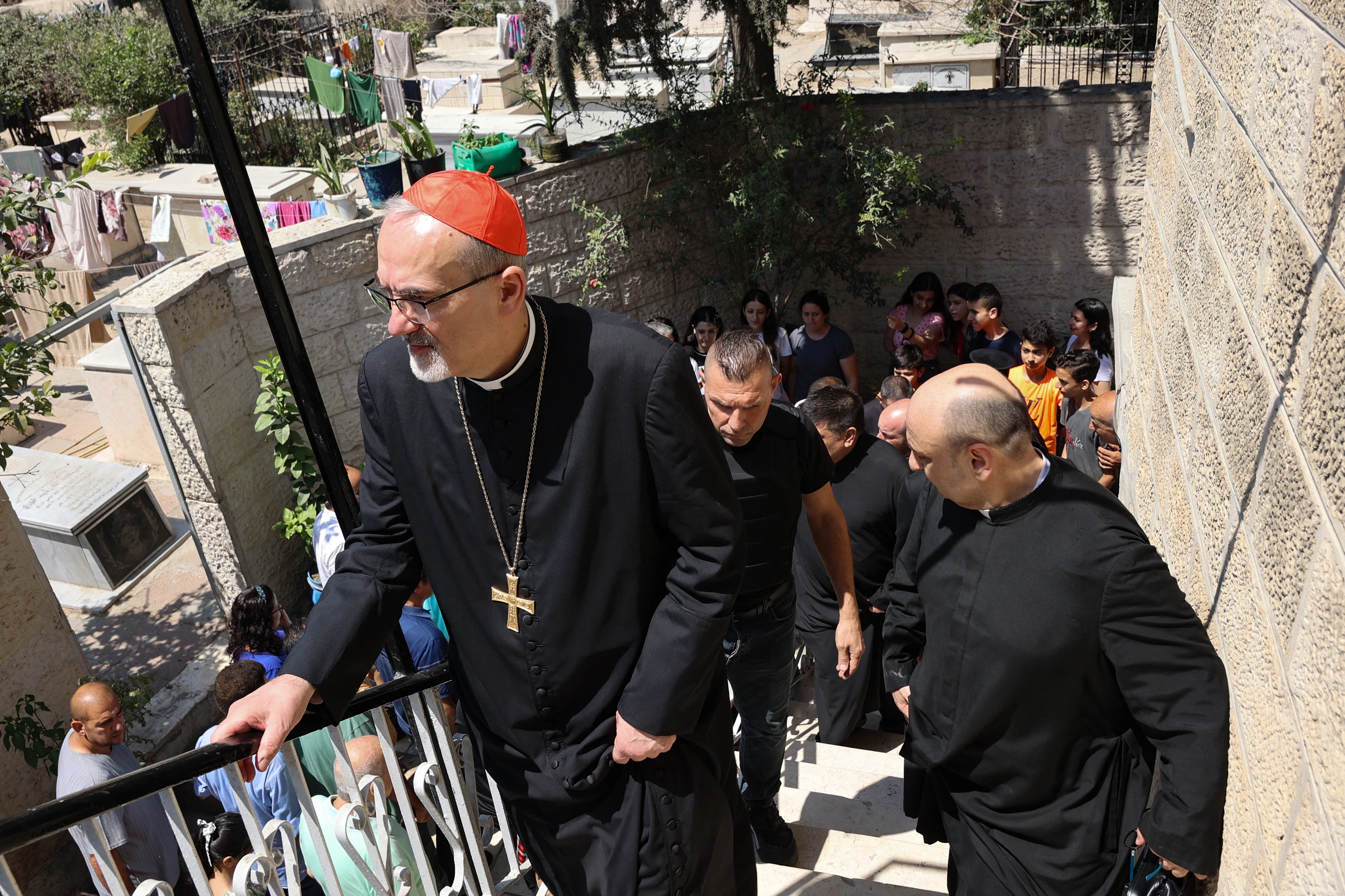 Latin Patriarch of Jerusalem Pierbattista Pizzaballa (left) and a members of a Christian visit St. Porphyrius Church in Gaza City on July 18, 2025.?w=200&h=150
