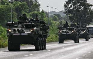 Royal Thai Army soldiers are pictured on armored vehicles on a road in Chachoengsao province on July 24, 2025. Credit: LILLIAN SUWANRUMPHA/AFP via Getty Images