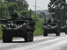 Royal Thai Army soldiers are pictured on armored vehicles on a road in Chachoengsao province on July 24, 2025.