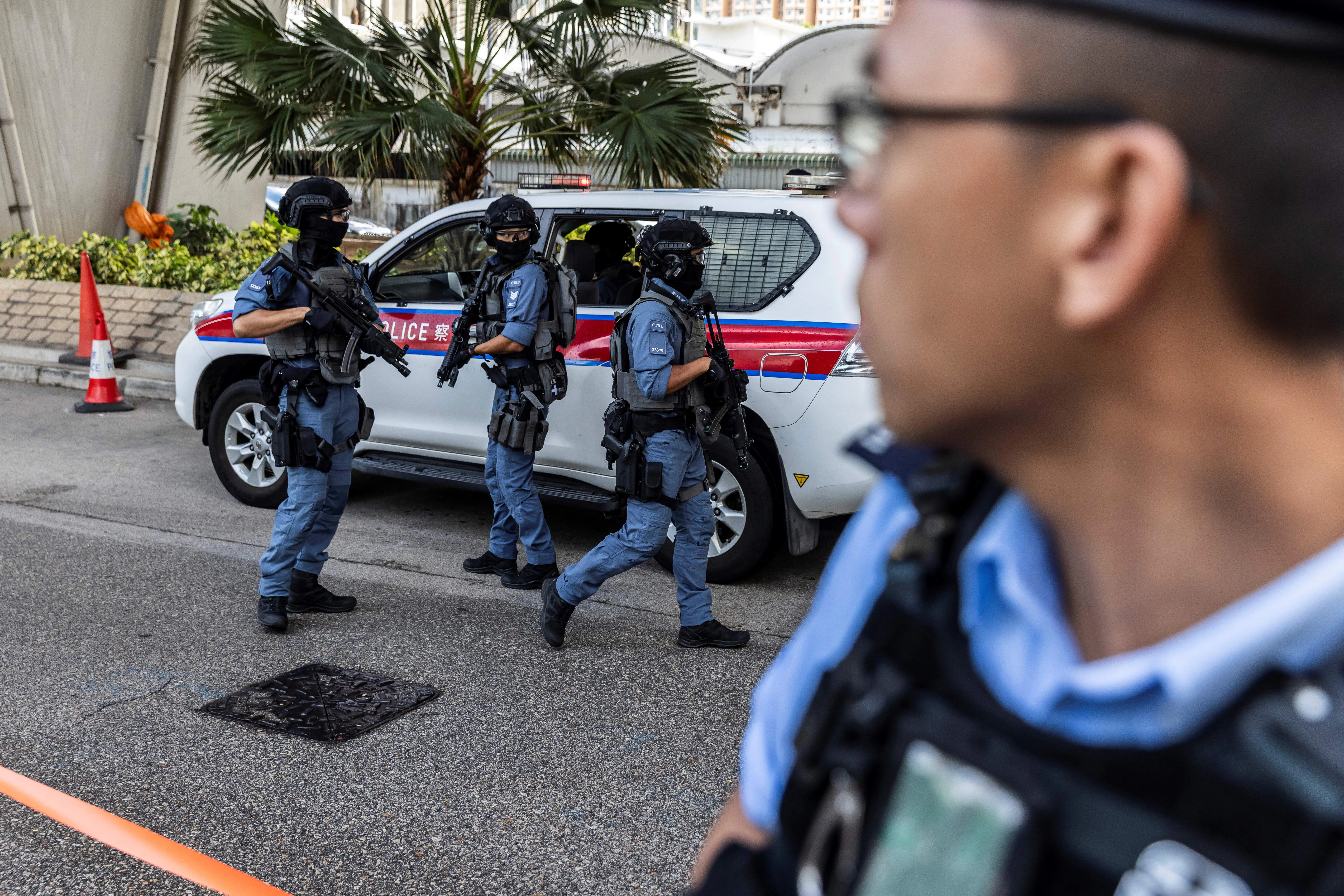 Police with automatic weapons guard outside the West Kowloon court after Hong Kong media mogul Jimmy Lai arrived for his national security trial in Hong Kong on Aug. 15, 2025.?w=200&h=150