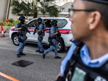 Police with automatic weapons guard outside the West Kowloon court after Hong Kong media mogul Jimmy Lai arrived for his national security trial in Hong Kong on Aug. 15, 2025.