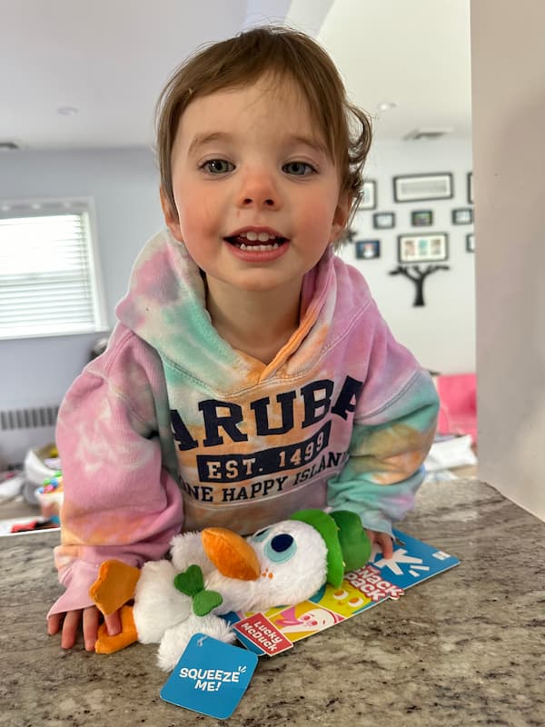 Child with toy from BARK Snack Pack Treats For Dogs