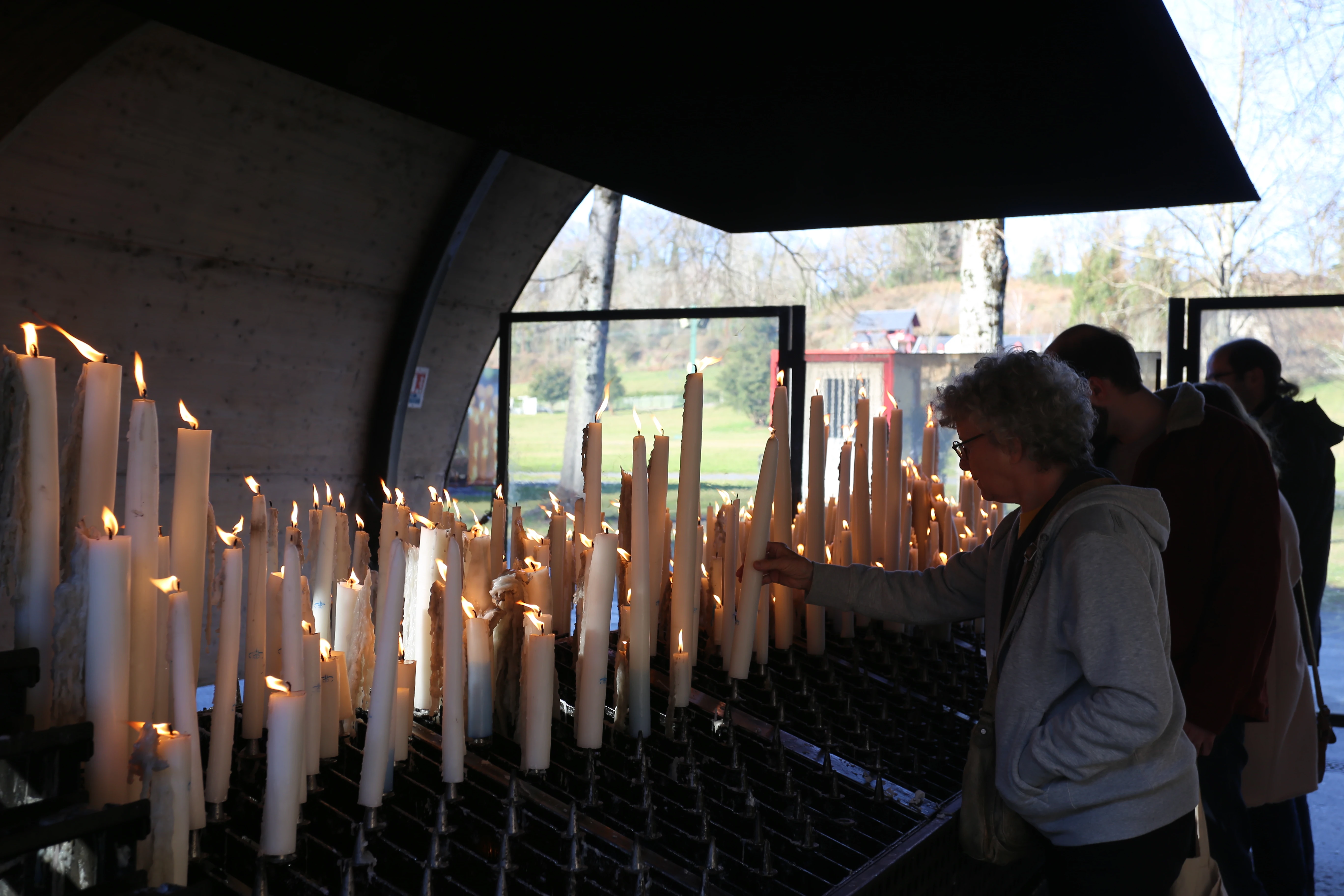 Pilgrims light candles at the Shrine of Our Lady of Lourdes in France.?w=200&h=150