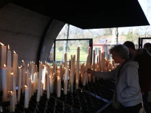 Pilgrims light candles at the Shrine of Our Lady of Lourdes in France.