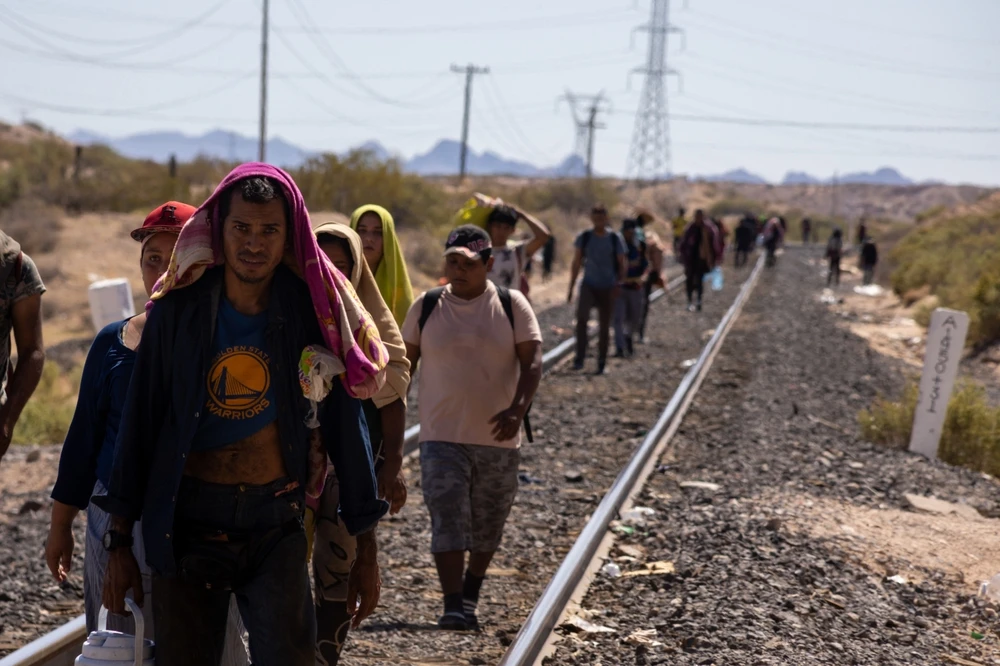 Migrants walk alongside the railroad tracks after dismounting from the “La Bestia” train, which they rode through Mexico to reach the Mexico-U.S. border near Chihuahua, Mexico, on Sept. 27, 2023.?w=200&h=150