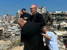 Cardinal Pierbattista Pizzaballa tours the war-torn area surrounding Holy Family Church with the parish’s pastor in Gaza, Father Gabriel Romanelli.
