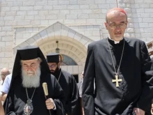 The Latin Patriarch of Jerusalem, Cardinal Pierbattista Pizzaballa, and Greek Orthodox Patriarch Theophilos III, leave the church after a visit to Holy Family Parish in Gaza on July 18, 2025.