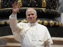 Pope Leo XIV waves to the crowd at his Wednesday general audience in St. Peter’s Basilica on Aug. 13, 2025.