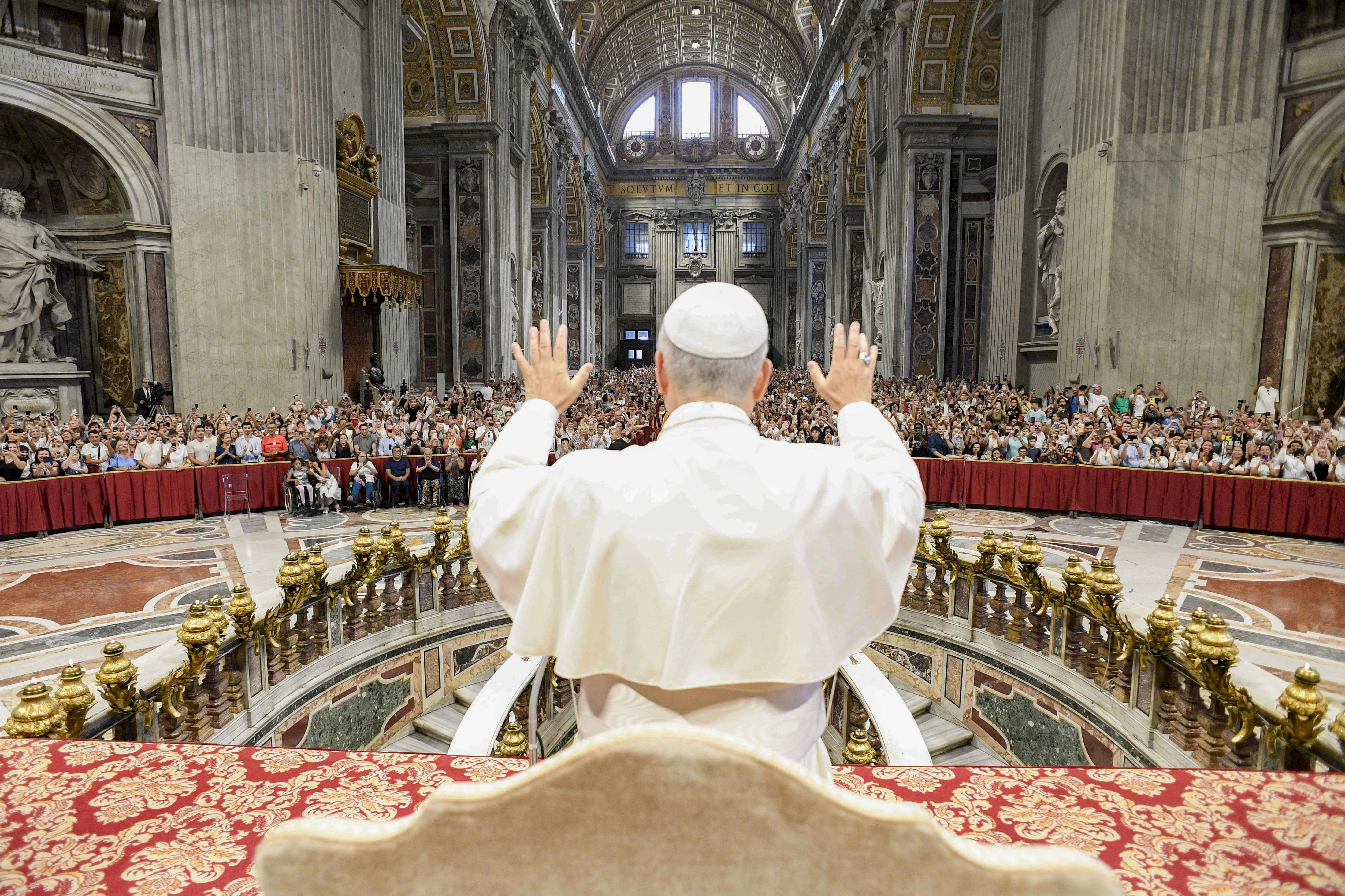 Pope Leo XIV blesses the crowd at his Wednesday general audience in St. Peter’s Basilica on Aug. 13, 2025, at the Vatican. Due to the heat, the pope gave his address in Paul VI Audience Hall but also greeted pilgrims in other locations.?w=200&h=150