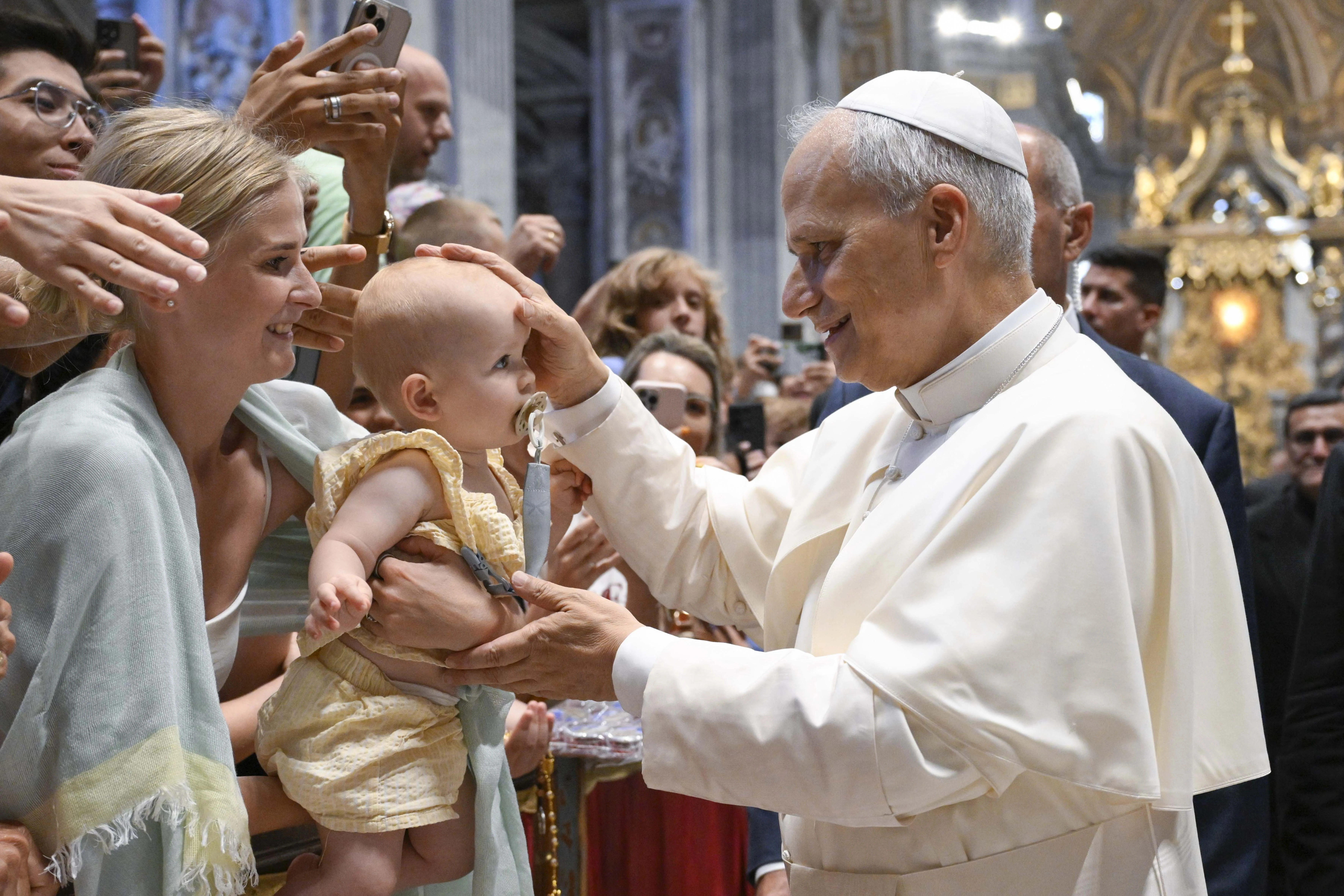 Pope Leo XIV blesses a baby during his Wednesday general audience in St. Peter’s Basilica on Aug. 13, 2025, at the Vatican.?w=200&h=150