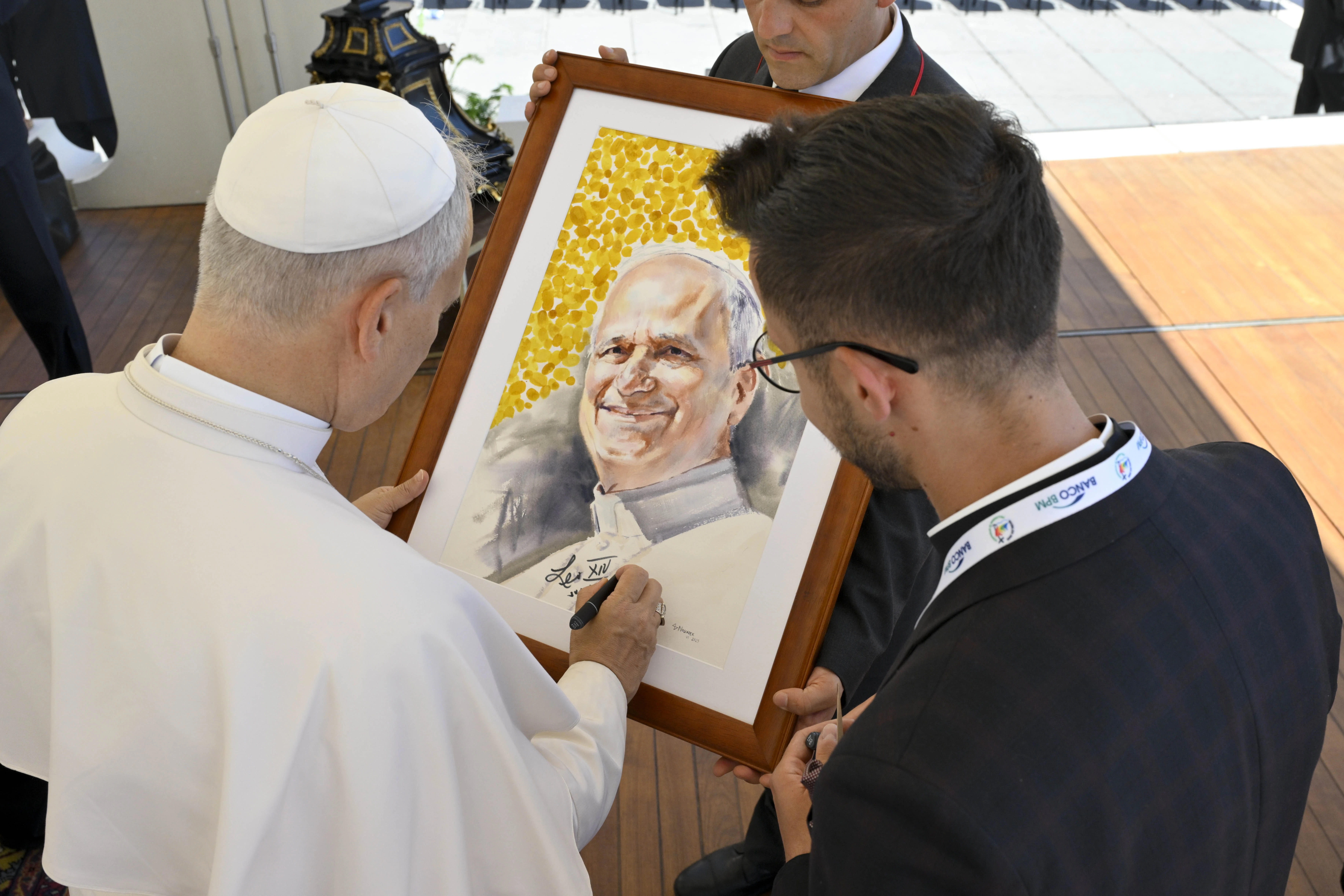 Pope Leo XIV signs a portrait of himself for a pilgrim at his general audience on July 30, 2025, in St. Peter’s Square at the Vatican.?w=200&h=150