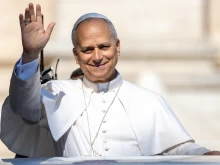Pope Leo XIV waves to pilgrams gathered in St. Peter’s Square at the Vatican for his Wednesday general audience on Aug. 6, 2025.