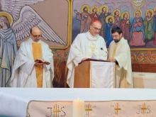 Father Gabriel Romanelli with Cardinal Pierbattista Pizzaballa, Latin patriarch of Jerusalem, celebrating Christmas Mass at Holy Family Parish in Gaza in December 2024.