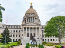 The Mississippi state capitol building. The Mississippi Access to Maternal Assistance (MAMA) program connects mothers and families with assistance from state and faith-based organizations like Catholic Charities.