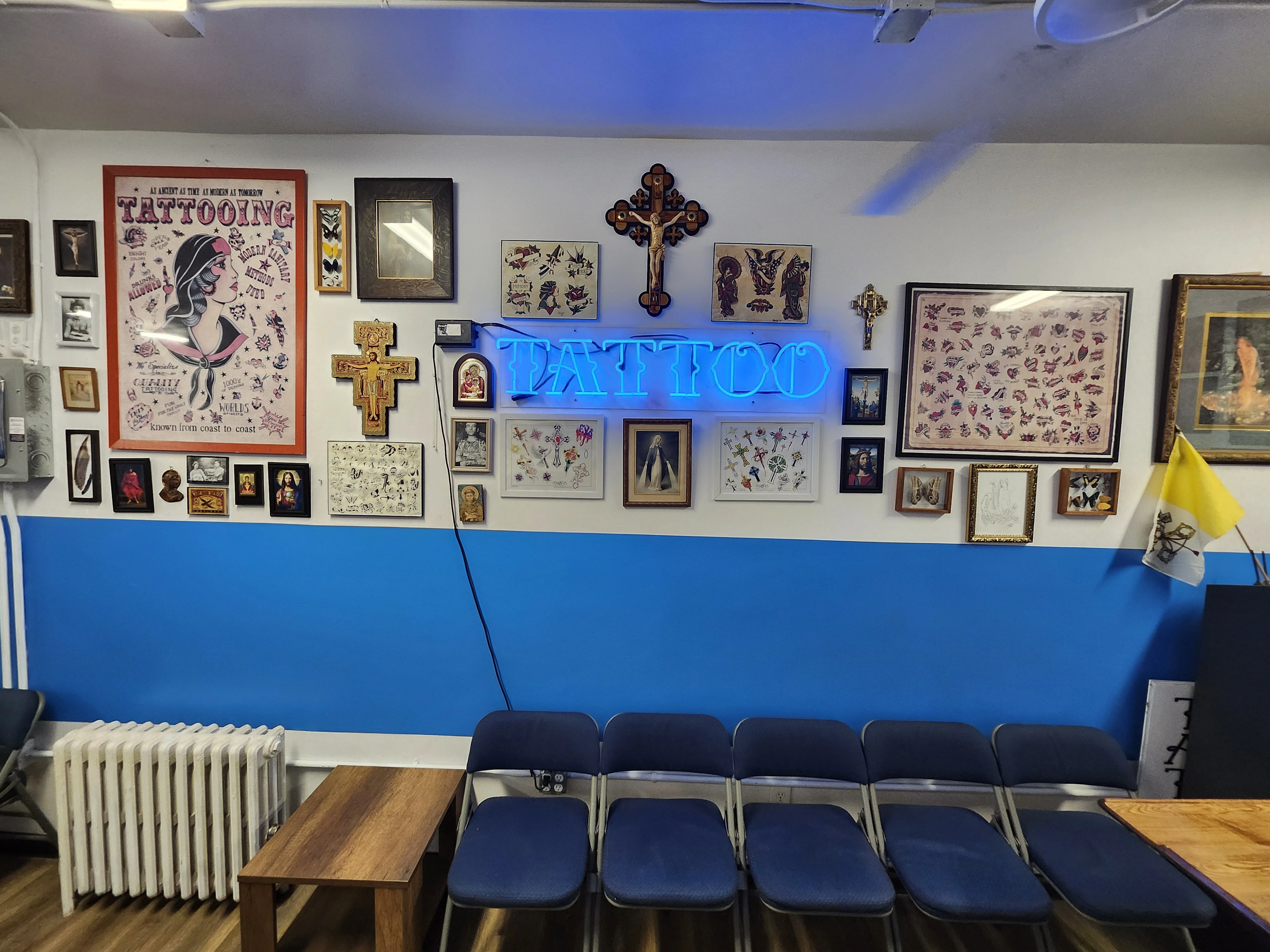 Catholic images and crucifixes fill the walls in Times Square Tattoo.?w=200&h=150